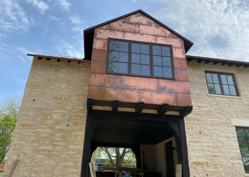 Copper metal panel facade on a stone building for Roof Repair in Perryville