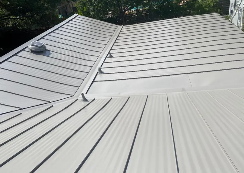 Solar attic fan installed on a metal roof for Roof Ventilation in Perryville